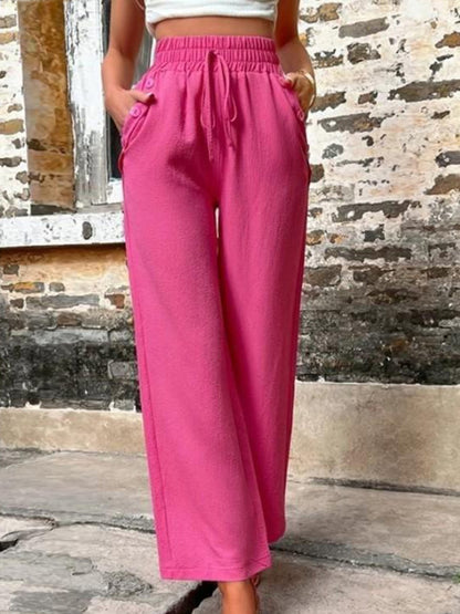 Pantalones anchos de cintura alta con bolsillos y cintura anudada