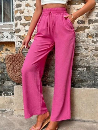 Pantalones anchos de cintura alta con bolsillos y cintura anudada