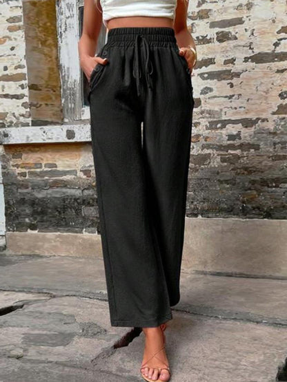 Pantalones anchos de cintura alta con bolsillos y cintura anudada