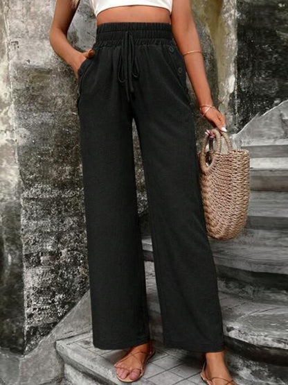 Pantalones anchos de cintura alta con bolsillos y cintura anudada