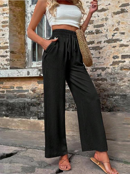 Pantalones anchos de cintura alta con bolsillos y cintura anudada