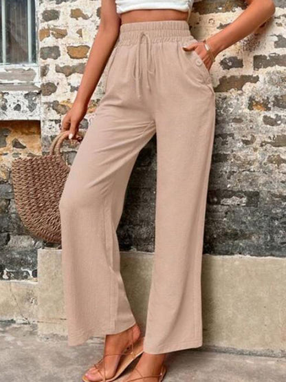 Pantalones anchos de cintura alta con bolsillos y cintura anudada