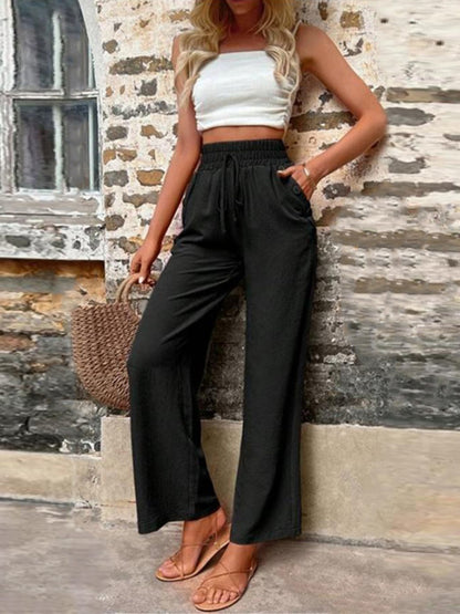 Pantalones anchos de cintura alta con bolsillos y cintura anudada