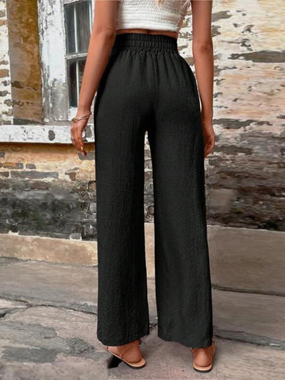 Pantalones anchos de cintura alta con bolsillos y cintura anudada